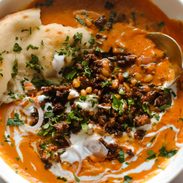 Carrot soup with ground beef topping.