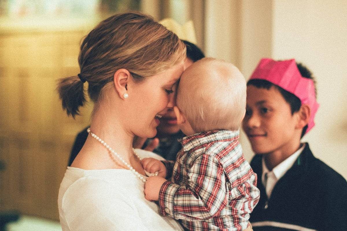 Woman holding a baby boy.