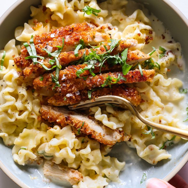 Creamy lemon pasta with chicken cutlet on top.