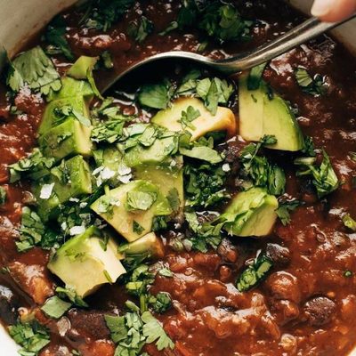 Instant Pot Pumpkin Walnut Chili in bowl with spoon.