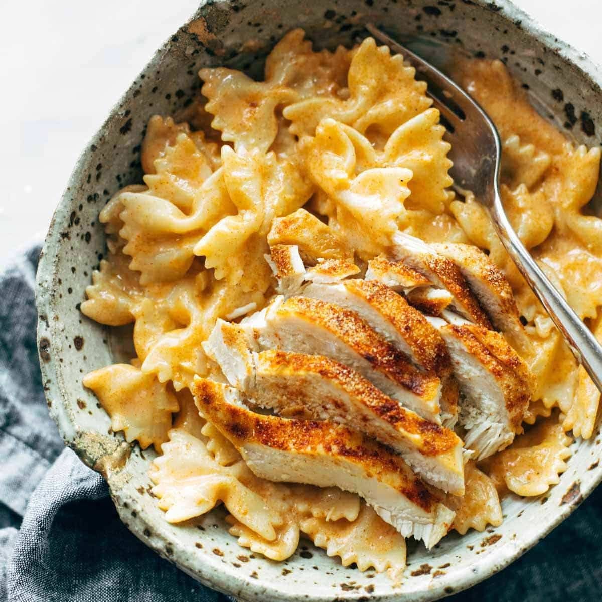 Paprika pasta in a bowl with sliced chicken