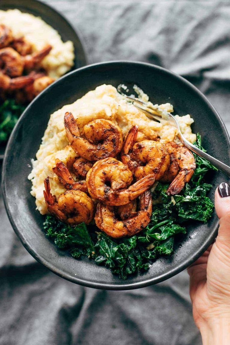 Spicy shrimp in a bowl with cauliflower mash and kale.