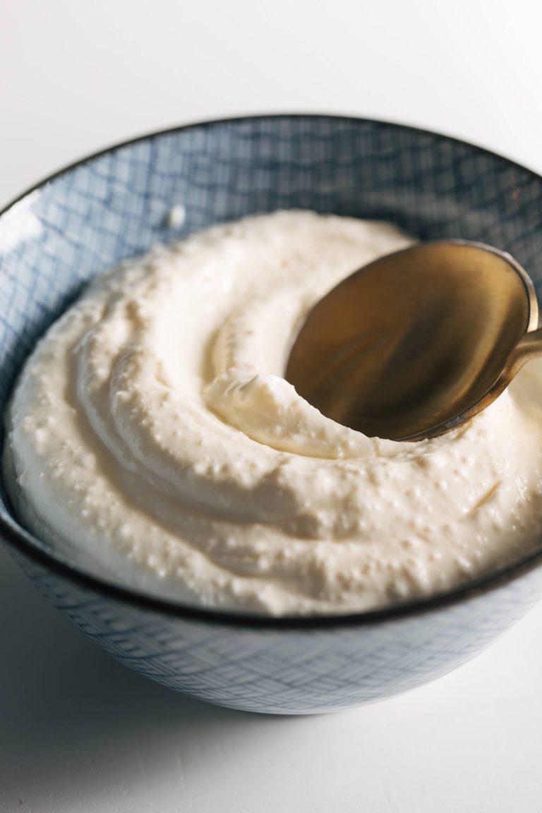Whipped feta in a bowl with a spoon.