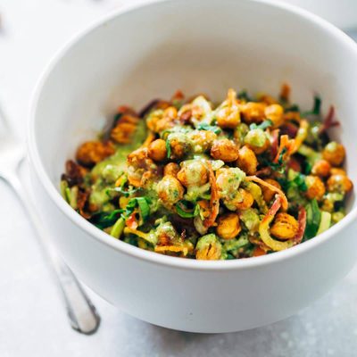 A white bowl with rainbow power salad.